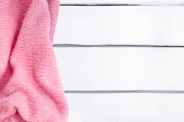 istock Background with pink knitted blanket on white wooden table, mockup 1367686486