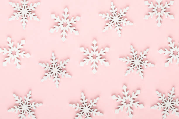istock Christmas background. White snow decorations on a pink background. 1367687693