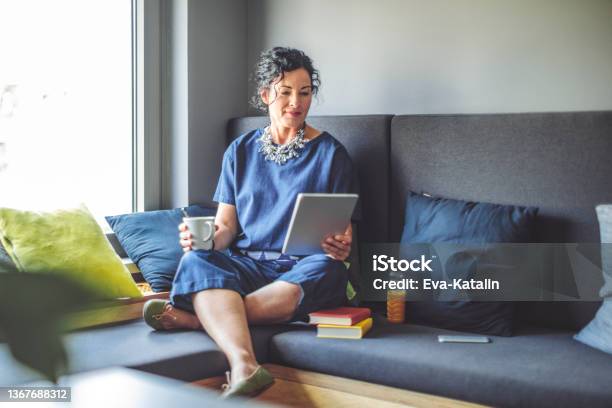 Businesswoman Taking A Break Stock Photo - Download Image Now - Mature Women, Digital Tablet, Women