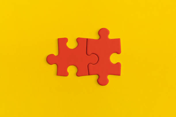 istock Red details of puzzle on yellow background. 1367690612