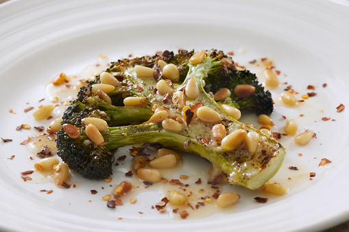 Roasted Broccoli Steak with Olive Oil, Pine Pins and Chili Flakes