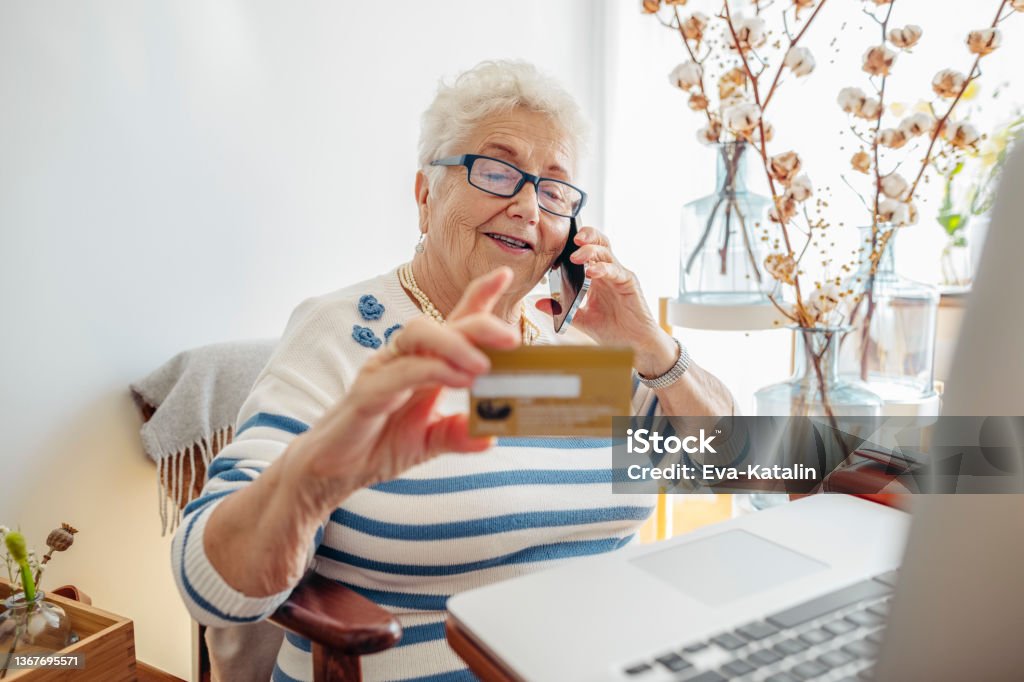 Senior woman at home Credit Card Stock Photo