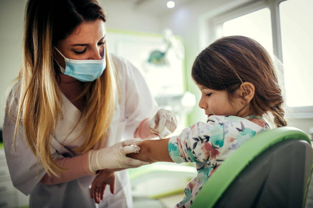 istock doctor vaccinating little girl 1367695706