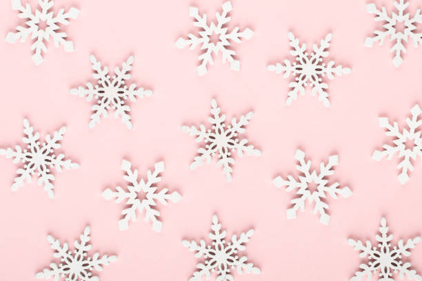 istock Christmas background. White snow decorations on a pink background. 1367698618
