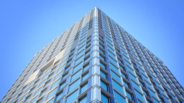 istock Commercial building close up in blue tone. Gigantic skyscraper from below. 1367699839