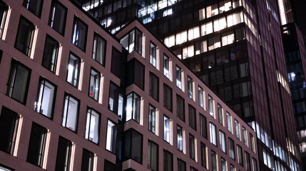 istock Office building at night, building facade with glass and lights. 1367700058