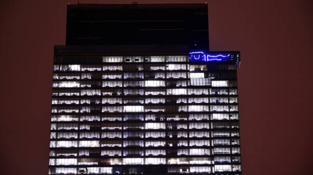istock Office building at night, building facade with glass and lights. 1367700142