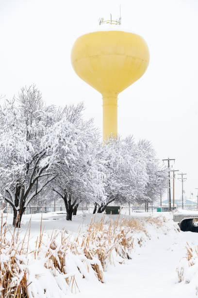 istock Yellow water tower in winter with irrigation canal 1367700774