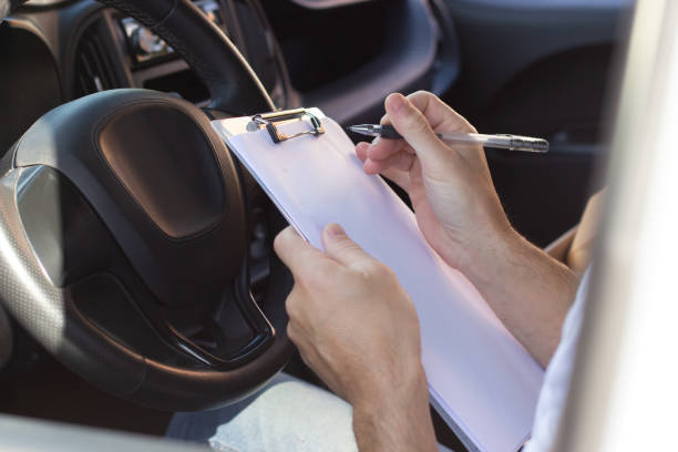 istock Close-up of deliveryman signing documents in car 1367700937