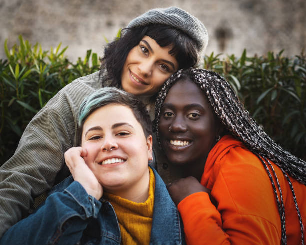 Portrait of multiracial diverse young woman smiling and looking at the camera Portrait of multiracial diverse young woman smiling and looking at the camera non binary gender stock pictures, royalty-free photos & images