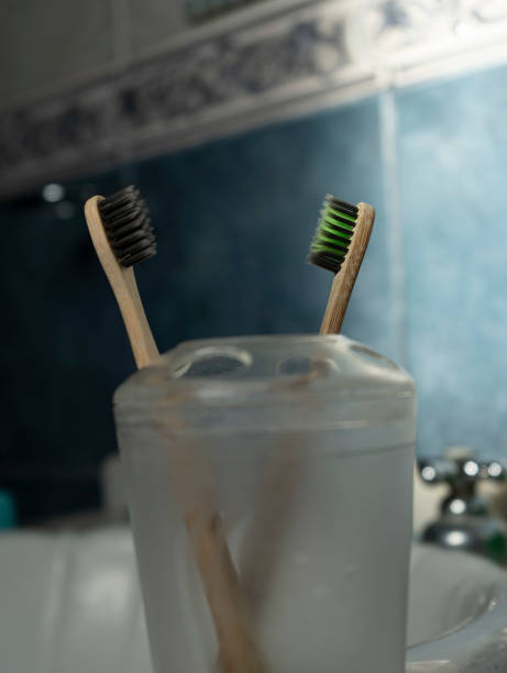 istock Two bamboo toothbrushes in a light blue bathroom 1367701542
