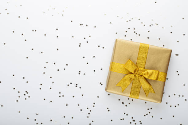 istock Gift or present box and stars confetti on color table top view. Flat lay composition for birthday, mother day or wedding. 1367702155