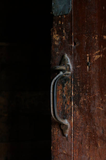 istock Old door latch and handle on a dark wooden door 1367702736