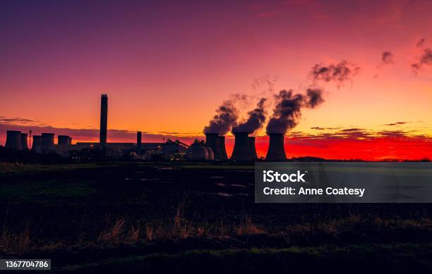 Silhouette Of A Power Station Against A Stunning And Colourful Winter Sunrise Near Drax In North Yorkshire Uk With Plumes Of Water Vapour Rising From The Cooling Towers Stock Photo - Download Image Now