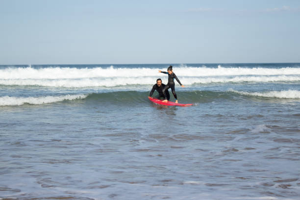 istock Helpful father and daughter doing sports on beach 1367704807
