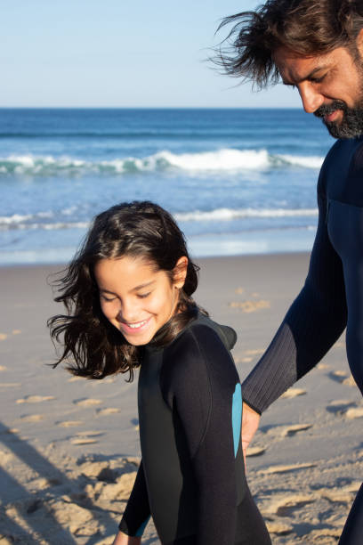 istock Joyful bearded father and daughter near ocean 1367705327
