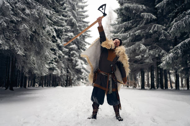 Mid-adult medieval warrior, raising the axe, as a sign to attack