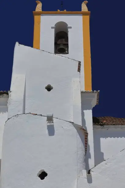Southeast face of the Saint James Church-Igreja Matriz de Santiago with its bell tower and protruding volumes resulting from the side chapels-sacristy-annexes of the interior. Tavira-Algarve-Portugal.