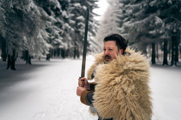 Mid-adult medieval warrior holding the sword, ready for a battle
