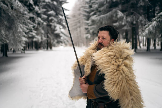 Mid-adult medieval warrior holding the sword, ready for a battle