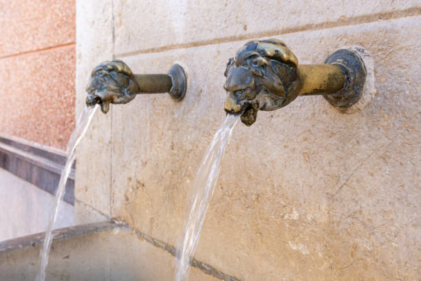 istock Bronze spouts in the fountain 1367706644