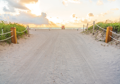 Pathway to the beach in Miami Beach Florida with ocean at sunrise
