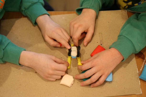 istock Children playing and creating a plasticine figure 1367707686
