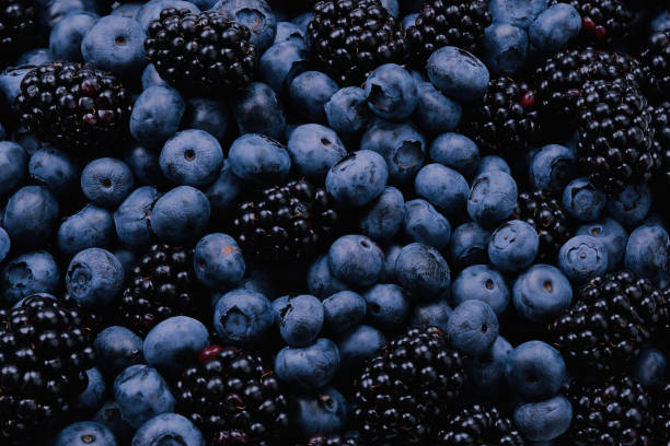 istock Blackberry and  blueberry background. Top view. 1367707817