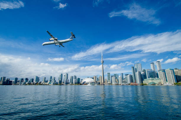 Flying over the skyline A propeller plane is preparing for landing in Billy Bishop airport (YTZ) and flying in front of Toronto's waterfront, as seen from Lake Ontario toronto photos stock pictures, royalty-free photos & images