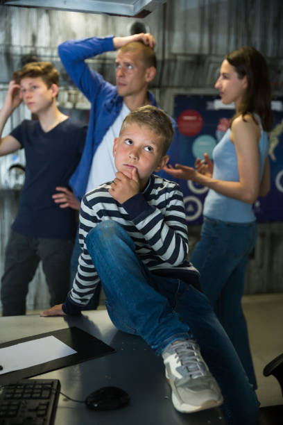 istock Brooding family tries to find a solution to a puzzle in a quest room 1367710269