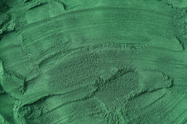 istock Green background texture made of gorund spirulina algae 1367710604