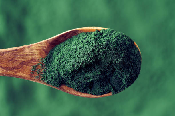 istock Spirulina bluegreen algae powder on a spoon 1367710665