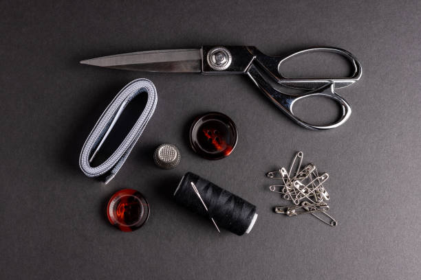 istock Sewing kit on black background with burgundy buttons 1367712859