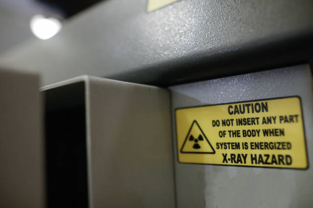 istock Shallow depth of field (selective focus) details with the Caution message on an X-ray baggage scanner machine. 1367713517