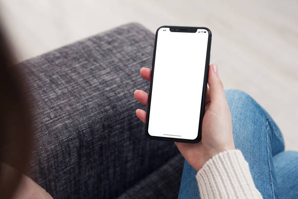 istock Woman looking blank smart phone display 1367715211