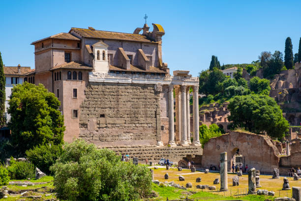 Roman Forum Romanum with Temple of Antoninus and Faustina and Palatine Hill in historic center of Rome in Italy Rome, Italy - May 25, 2018: Panorama of Roman Forum Romanum with Temple of Antoninus and Faustina San Lorenzo in Miranda church and Palatine Hill in historic center of ancient Rome san lorenzo rome photos stock pictures, royalty-free photos & images