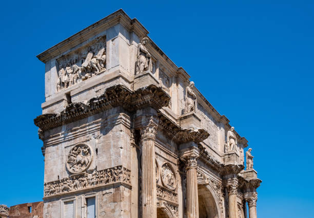 Arch of Constantine the Great emperor between Colosseum and Palatine Hill in historic city center of Rome in Italy Rome, Italy - May 25, 2018: Arch of Constantine the Great emperor Arco di Costantino between Colosseum and Palatine Hill at Via Triumphalis route in historic city center costantino stock pictures, royalty-free photos & images