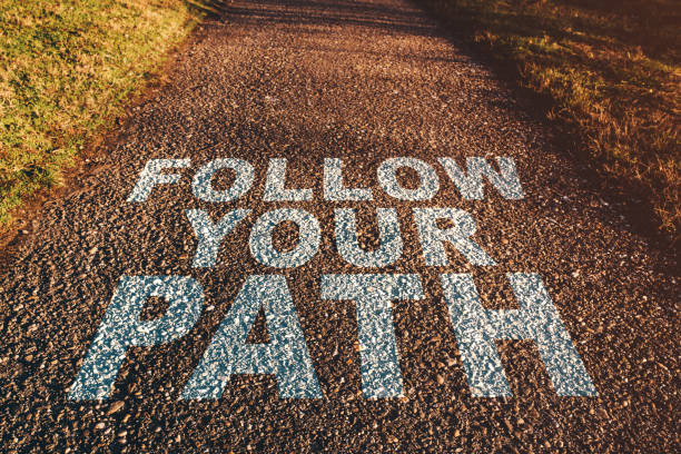 istock Follow your path concept, asphalt footpath in diminishing perspective 1367721532