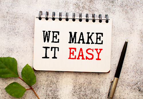We make it easy text on white notepad paper on white background NEXT TO THE CALCULATOR.