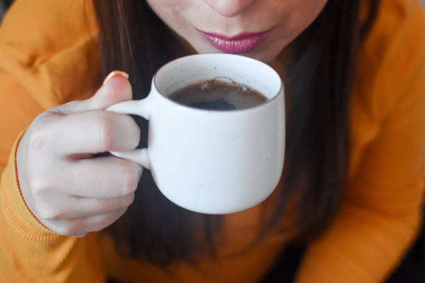 istock Woman indoors drinking coffee 1367726557