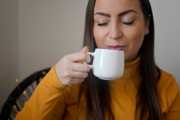 istock Woman indoors drinking coffee 1367727198