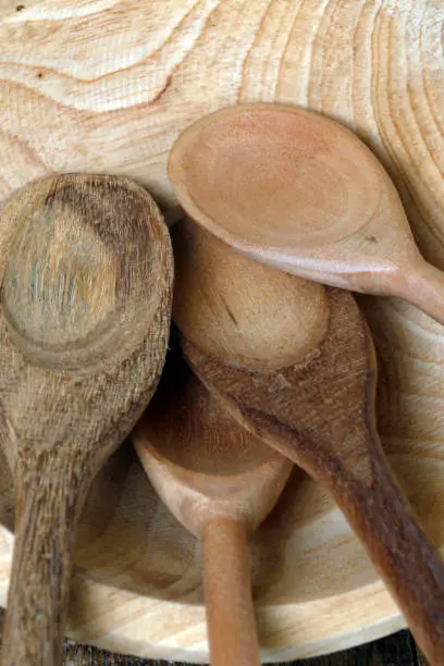 Photo of Wooden spoons on wooden trough