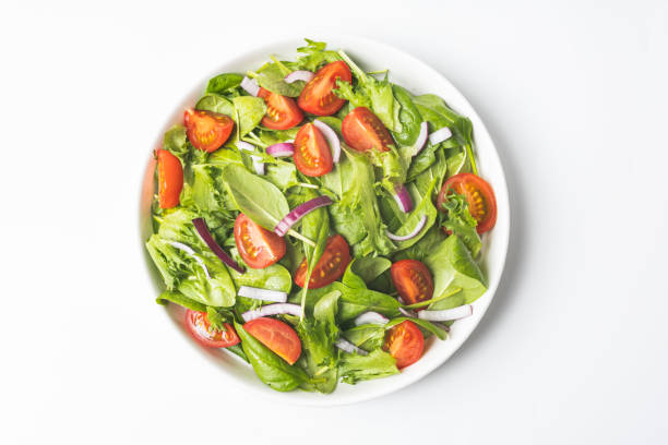 istock Summre green salad in white bowl plate on grey table 1367732639