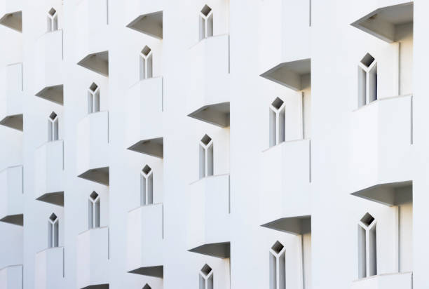 Repeating pattern of balconies and windows on a building in Algarve, Portugal. Whitewashed wall.
