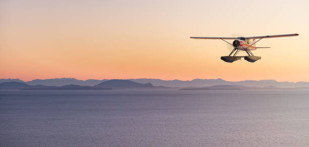 istock Seaplane Flying over the Pacific Ocean on the West Coast. Adventure Composite. 1367734512