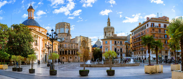 evening panoramic view of square of saint mary or virgens square with valencia cathedral temple, basilica de la nuestra senora de los desamparados and the rio tura fountain in old town valencia spain - valencia cathedral imagens e fotografias de stock