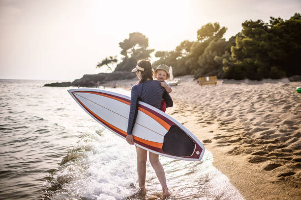istock Surf mother with a baby boy at the beach 1367737455