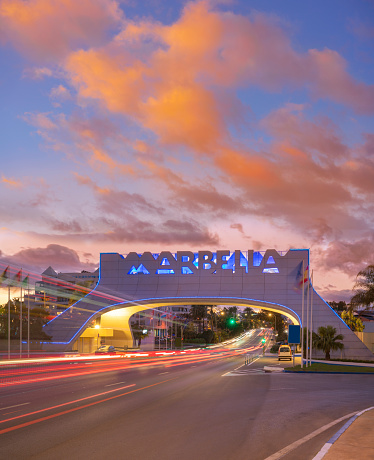 Marbella arch welcome sign at sunset with traffic light beams in costa del Sol of Malaga in Andalusia of Spain