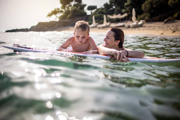istock Mother and son enjoy surfboarding 1367738510