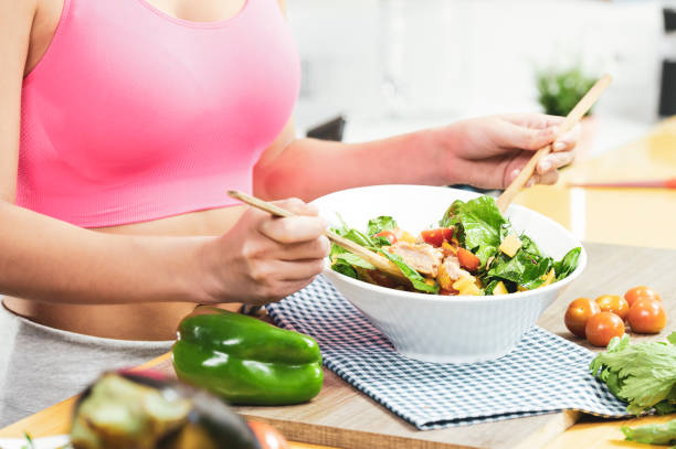 istock Pretty woman making a salad 1367742297